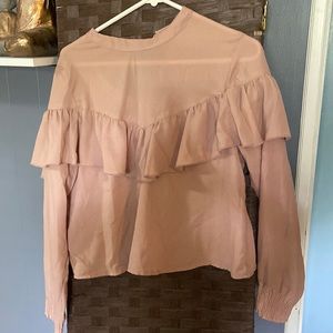 Cute ruffled top. Fits like a large. Arms are cuffed